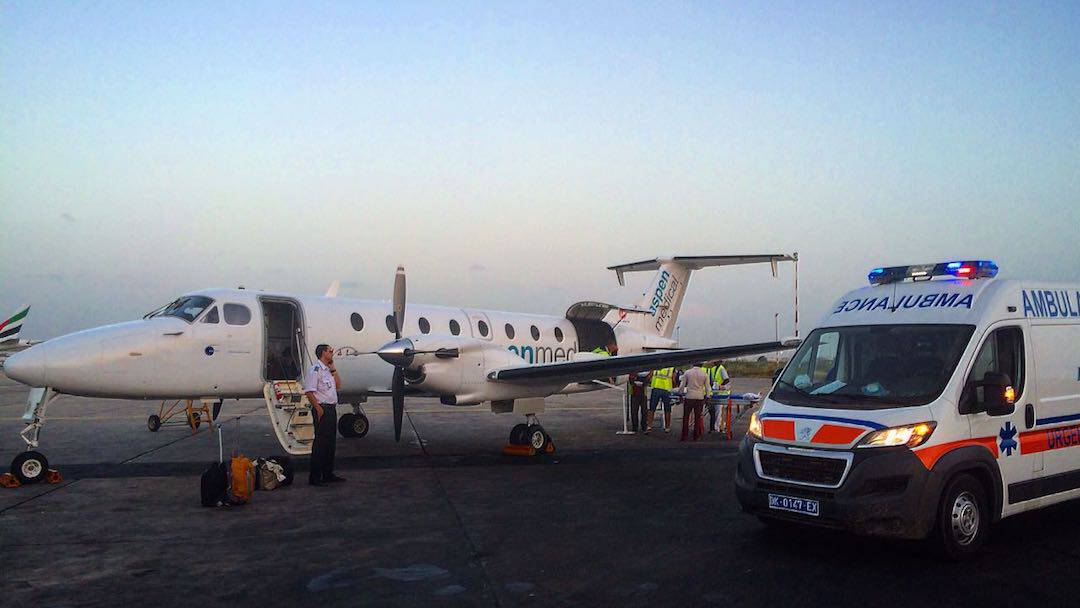 Aspen Medical workers near a company airplane and ambulance